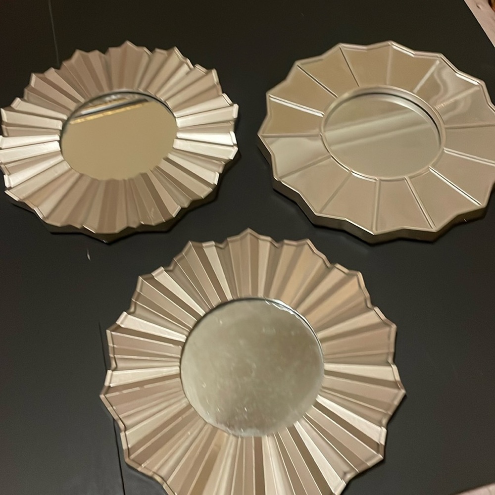 Three hanging mirrors